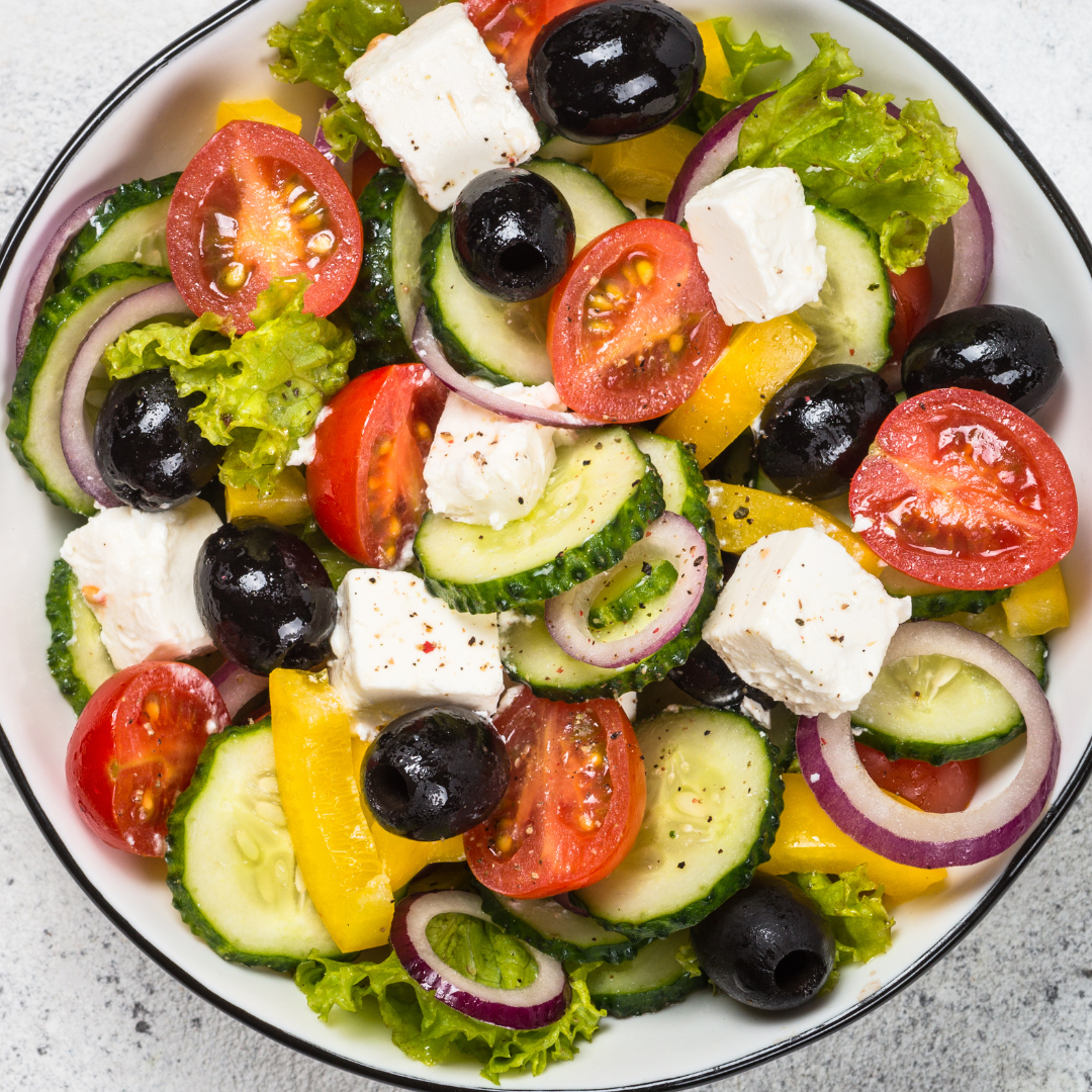 A vibrant Greek-inspired bowl with a balanced mix of seasoned protein, crisp vegetables, wholesome grains, and flavorful Mediterranean toppings — a refreshing and nourishing option.