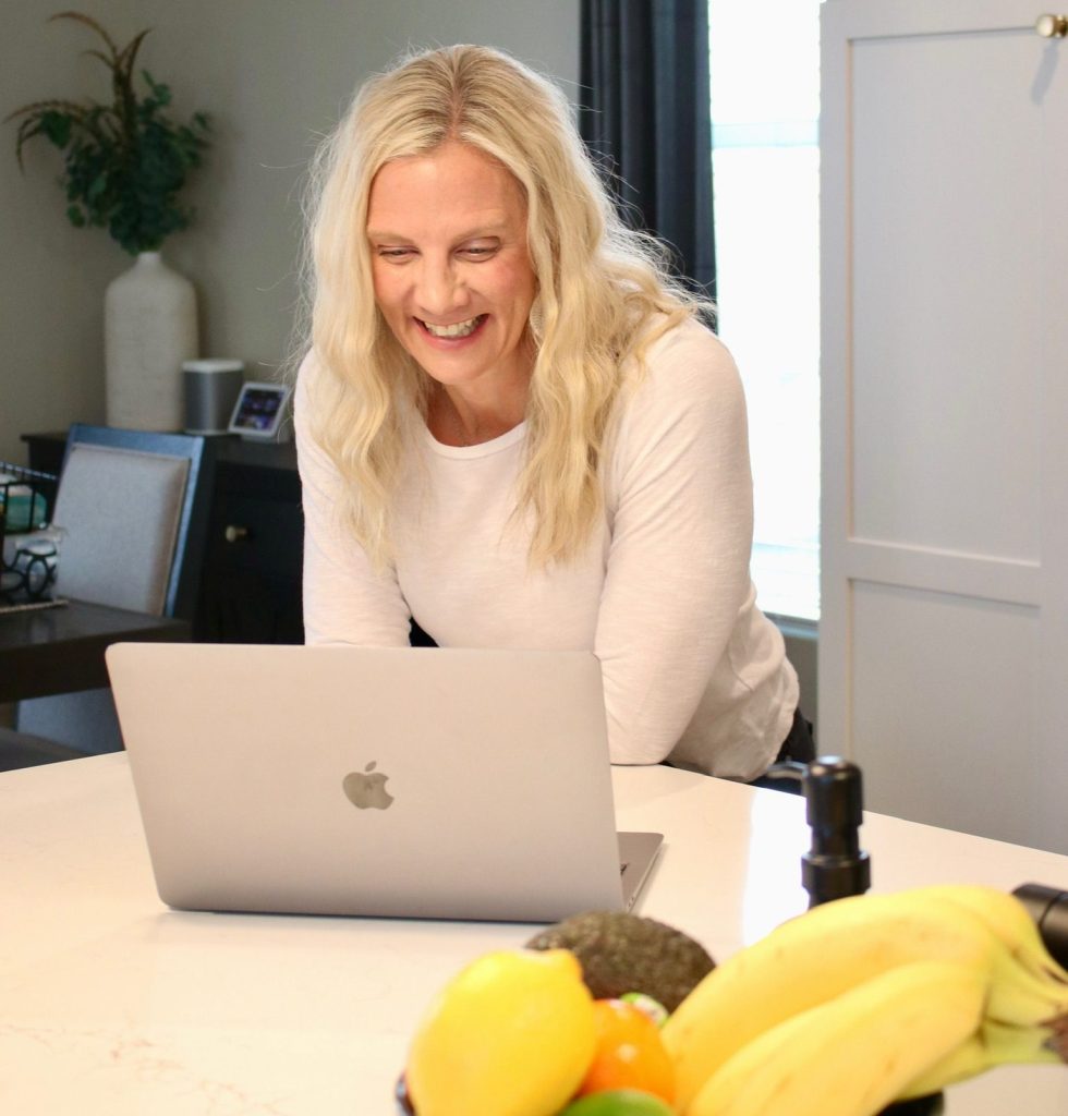 Amanda smiling and talking during a 1:1 virtual coaching call, offering personalized support and guidance.